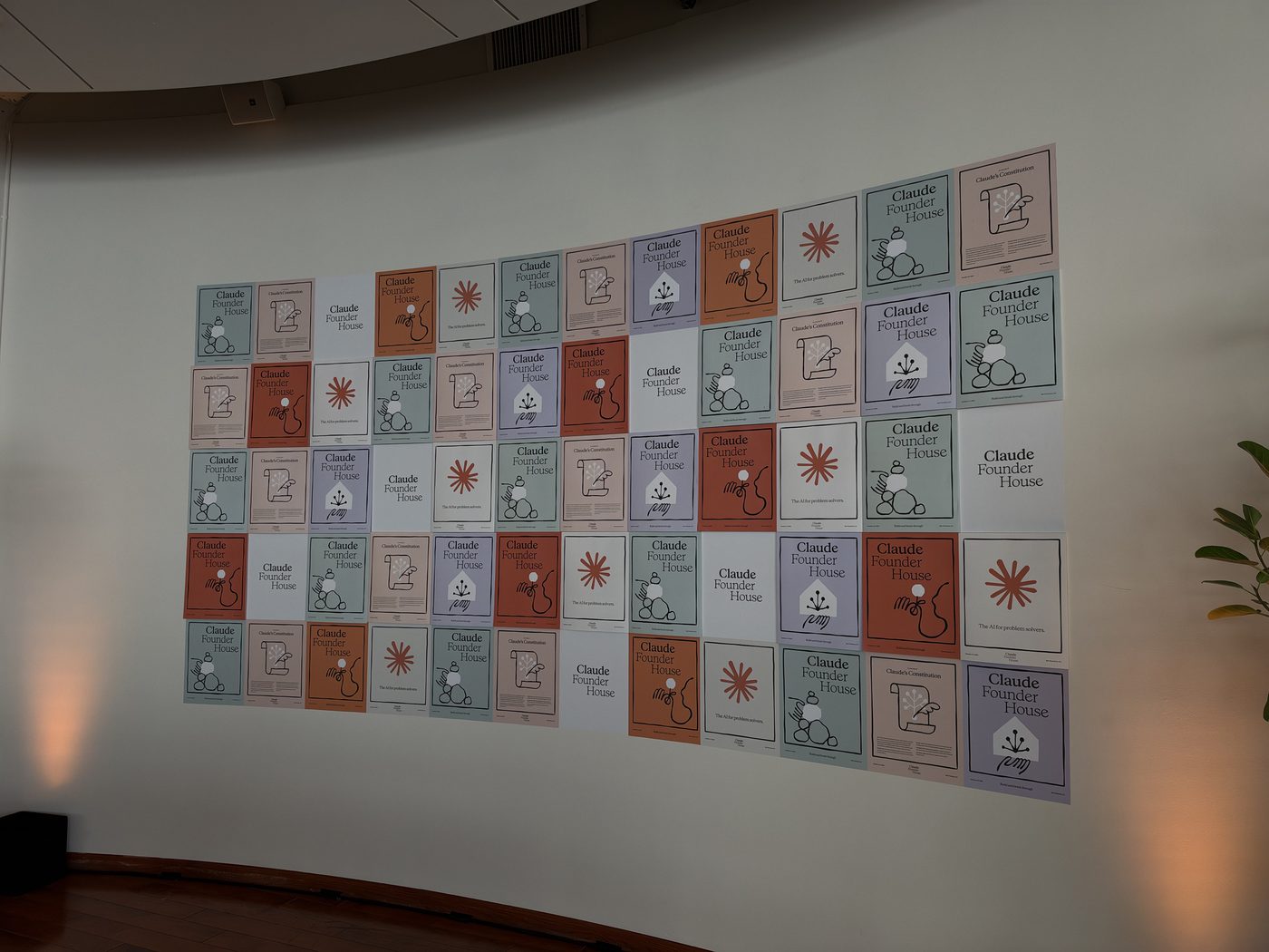 A wall of colorful Claude Founder House posters.